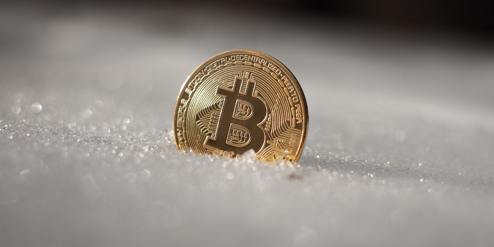 Bitcoin stuck in snow illustrating 
