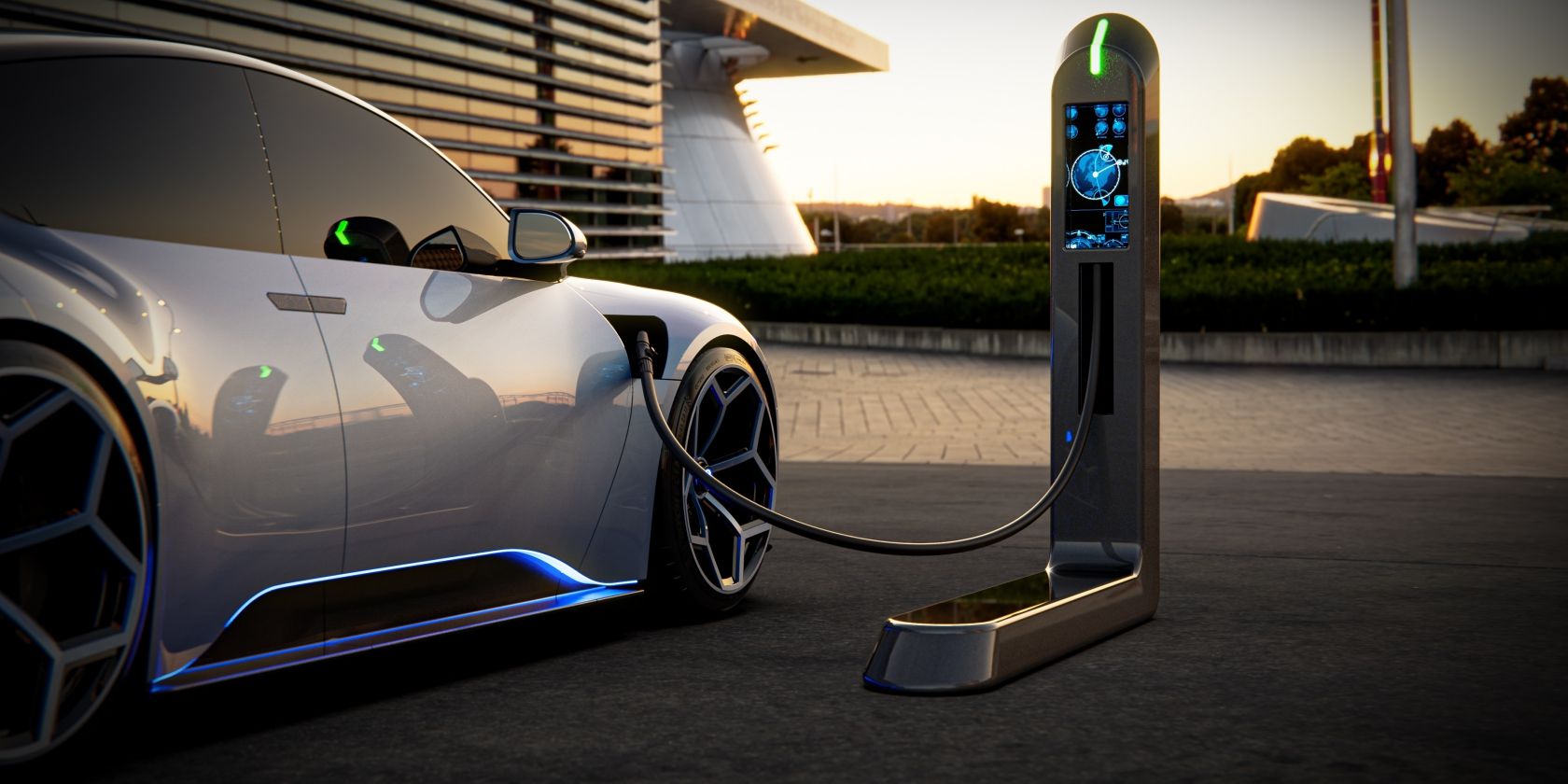 Silver EV sports car charging outdoors at night