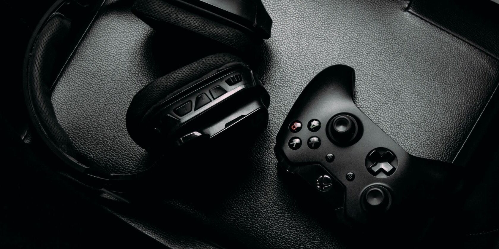 A photograph of an Xbox Wireless Controller next to a headset
