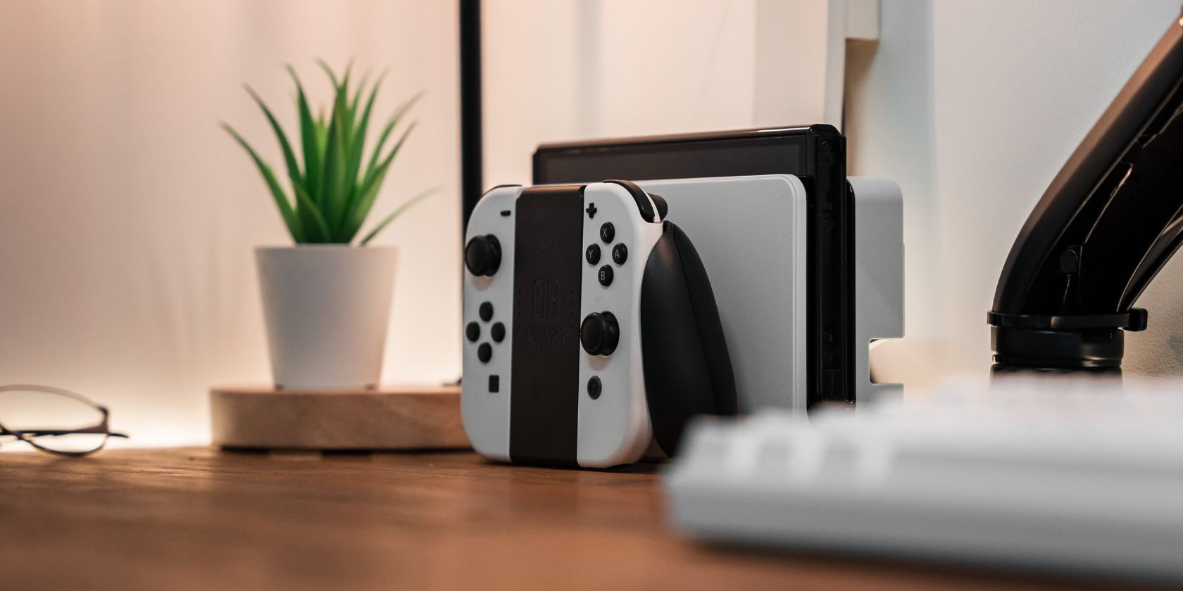 Nintendo Switch OLED white edition docked on a desk