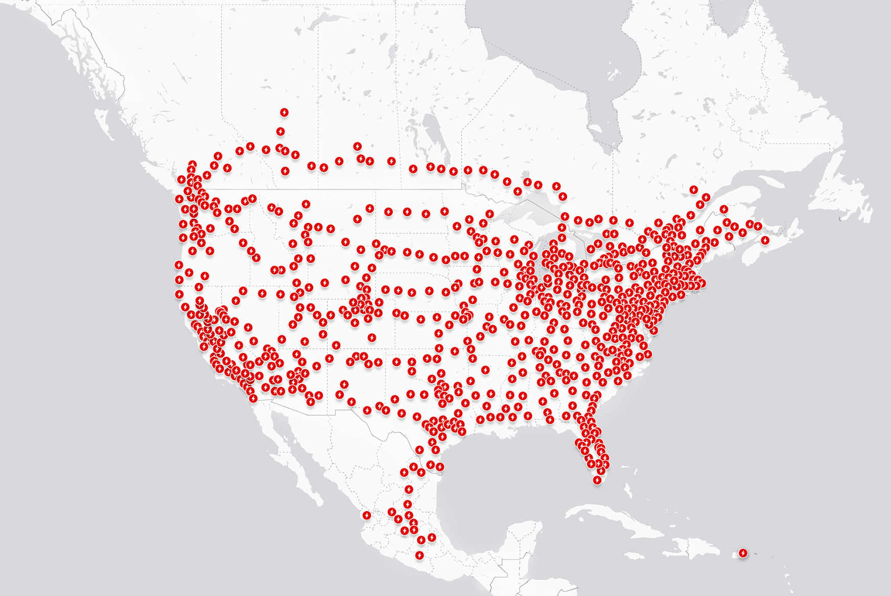 A map of North America with red dots designing Tesla Supercharger locations
