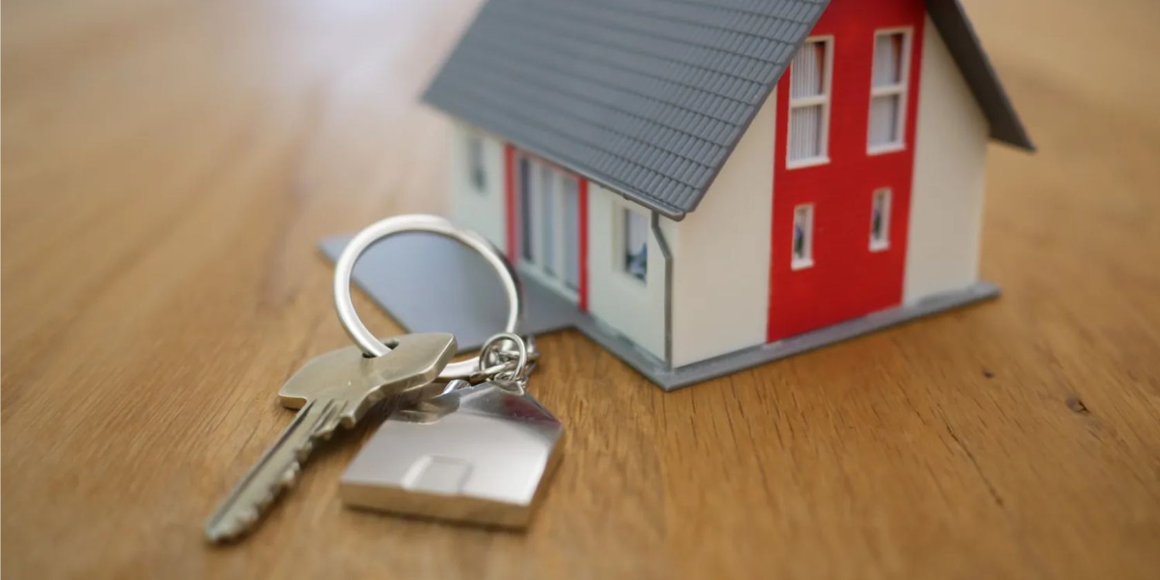 model house next to a set of keys
