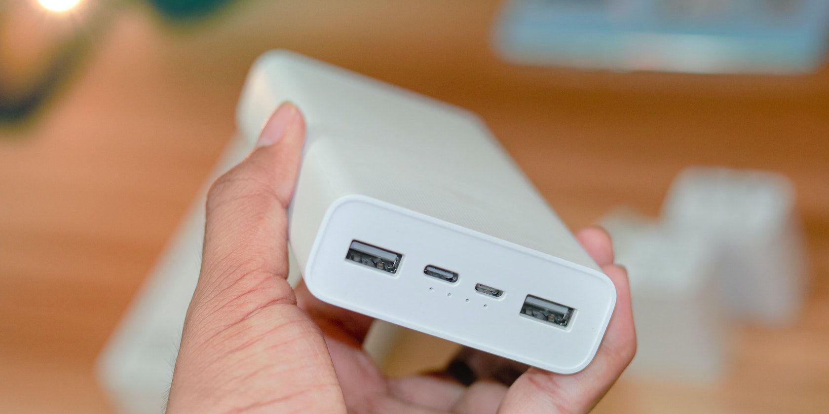 Someone holding a white mobile power bank