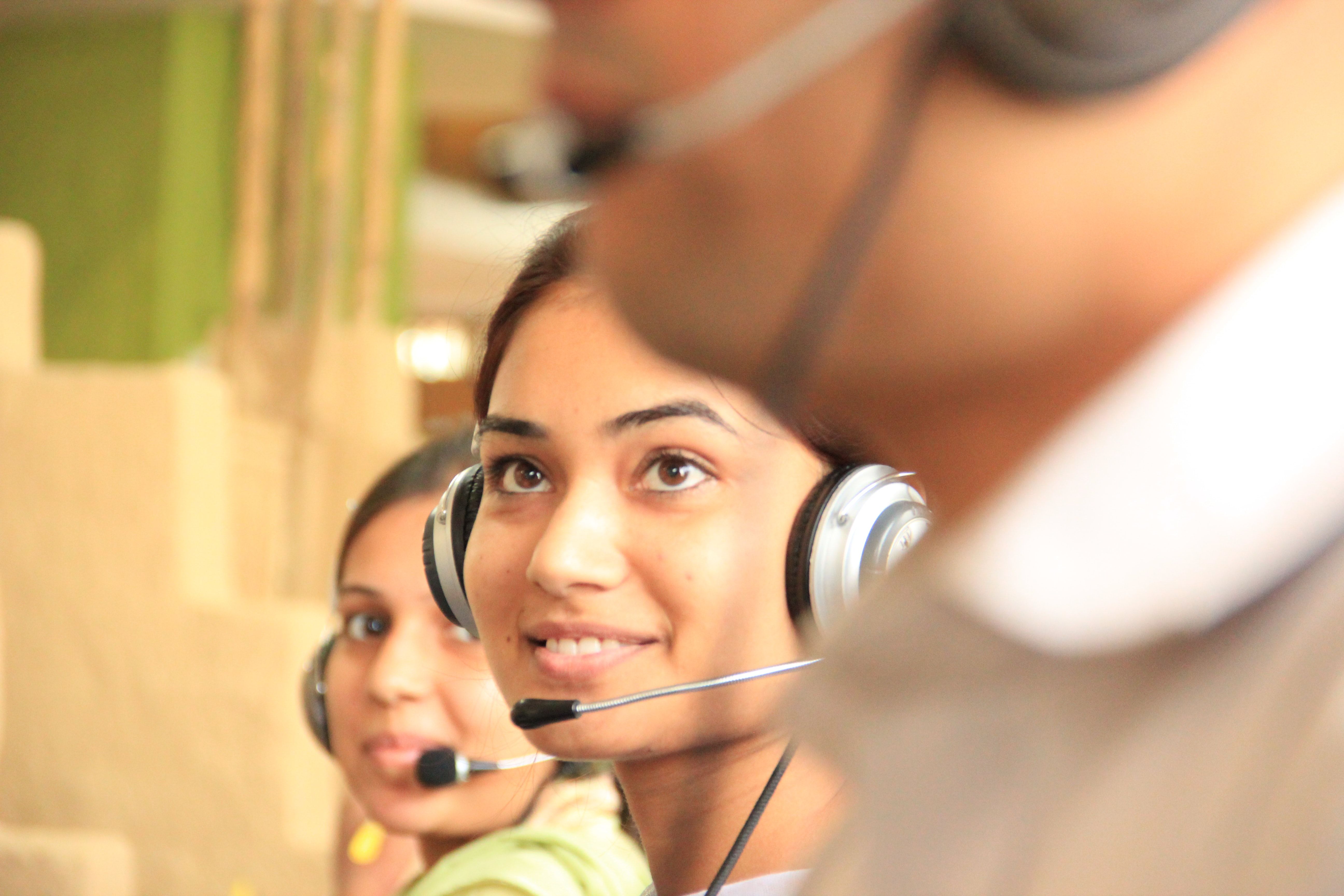 Three customer support representatives with headsets