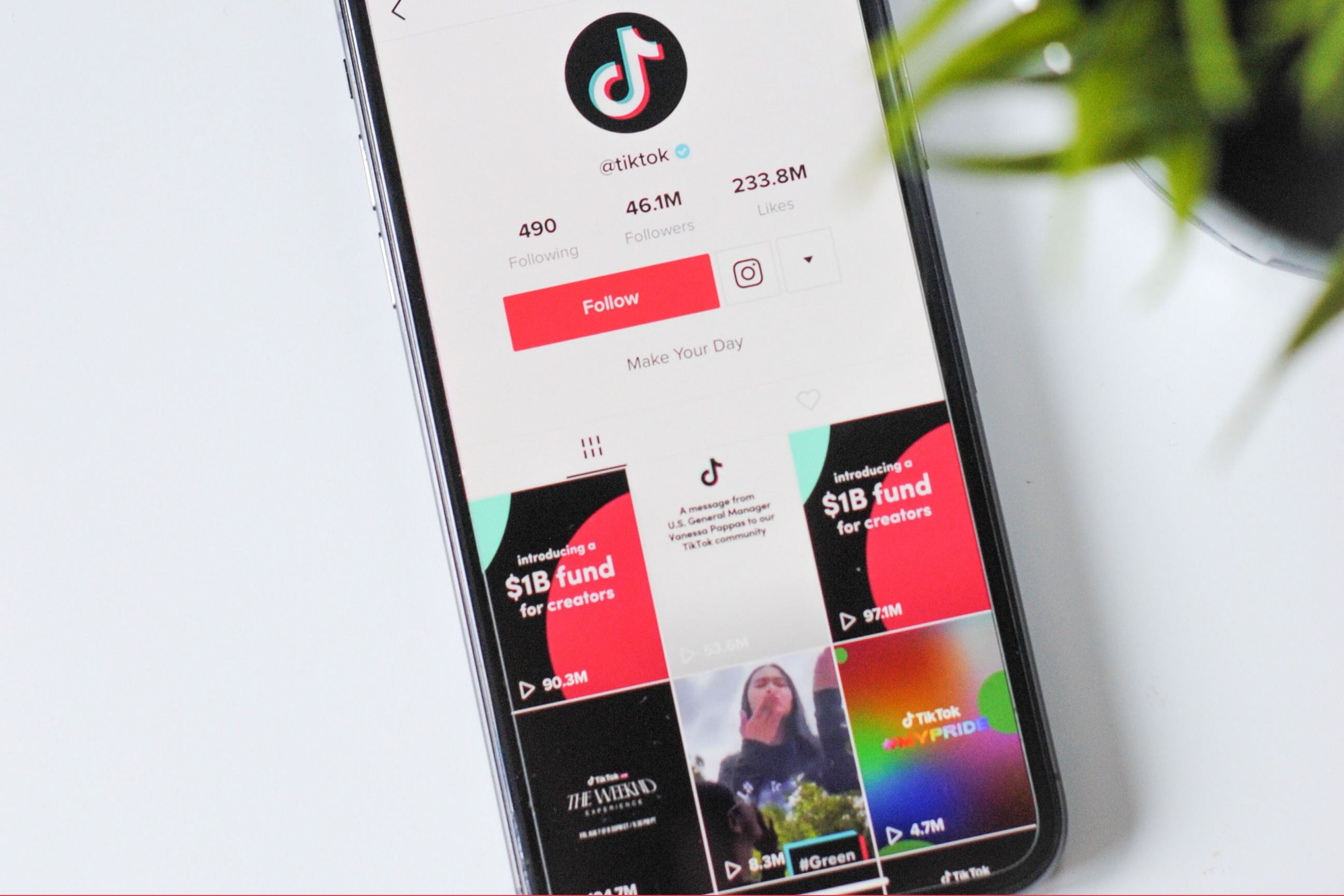 iPhone on table with TikTok homepage opened