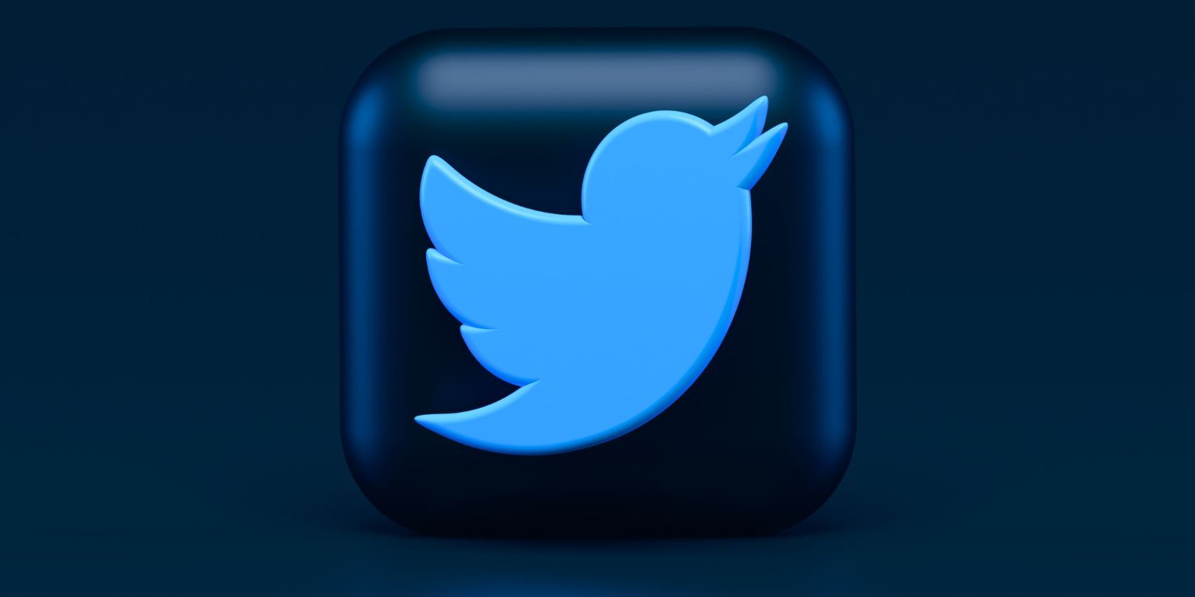 Twitter bird logo designed in 3D atop a plain navy background