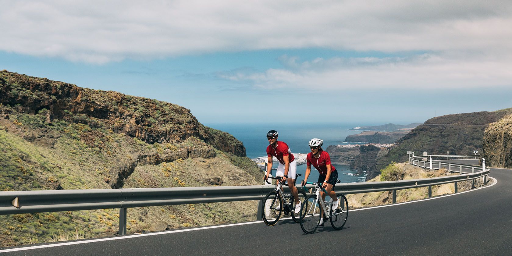 Two road cyclists on a winding road