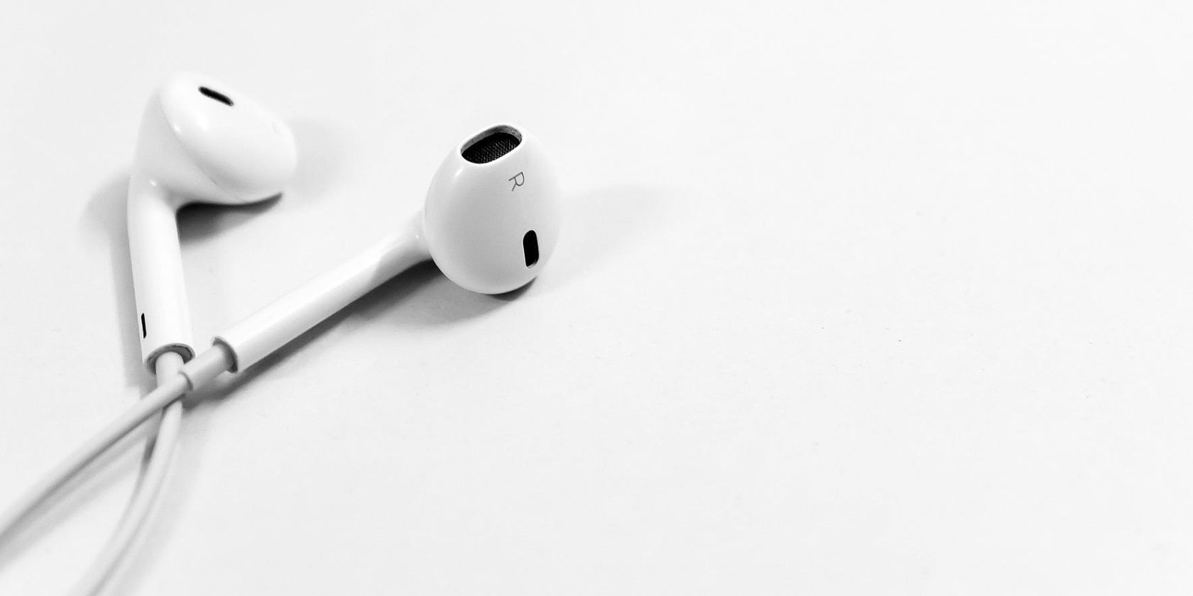 Apple headphones on a white canvas