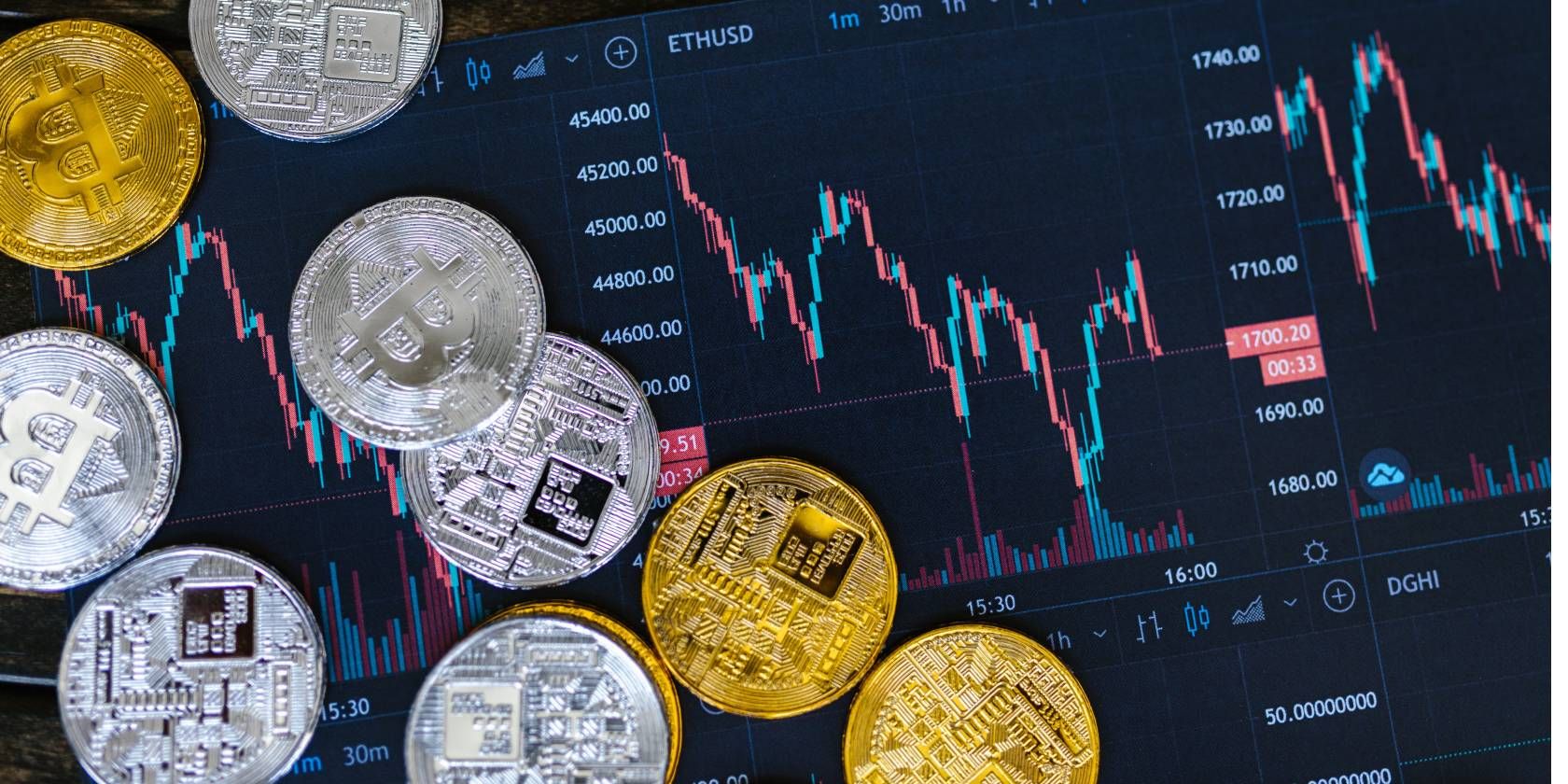 bitcoin, silver and gold coins on a printed ethereum price chart