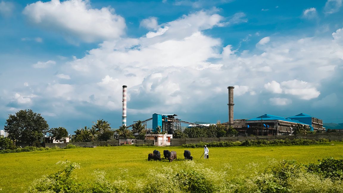 Factory in a lush field