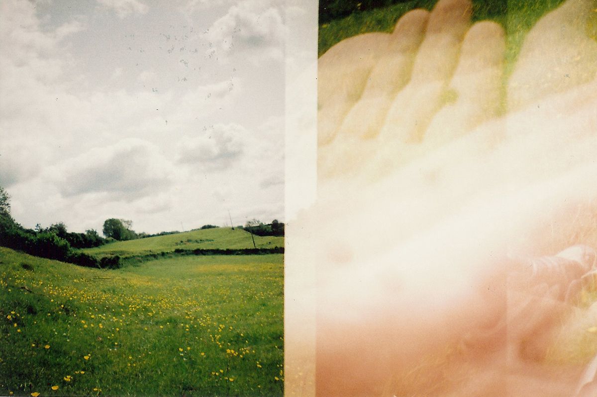 Landscape and double exposure of hand.