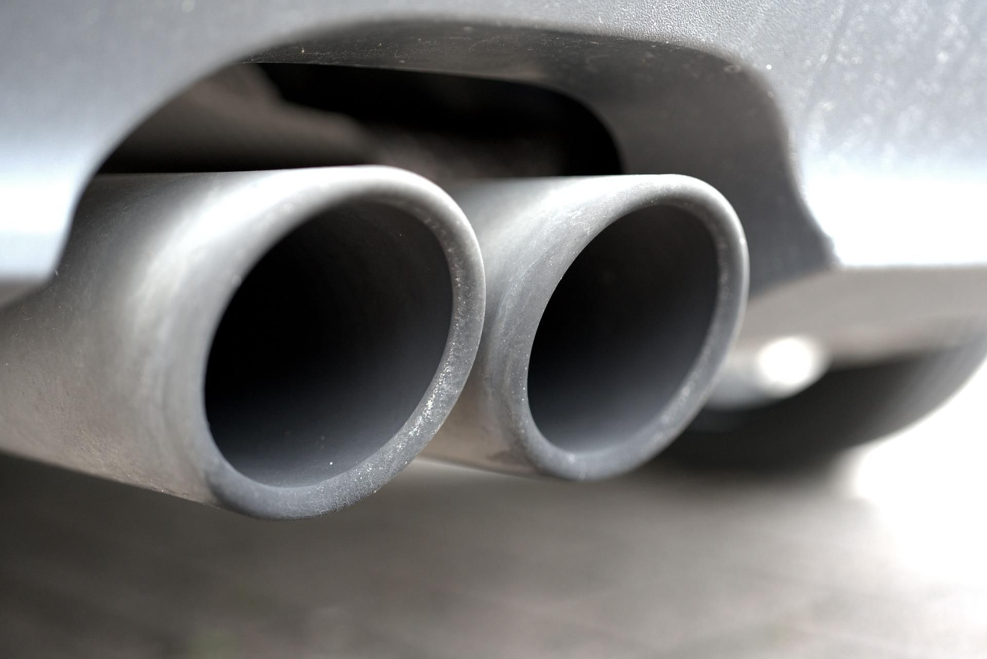 A close-up of a vehicle's dual exhaust pipes