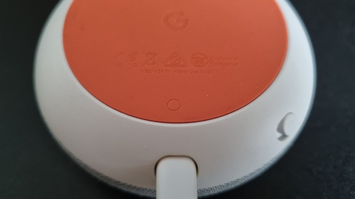 The reset button on a Google Home Mini
