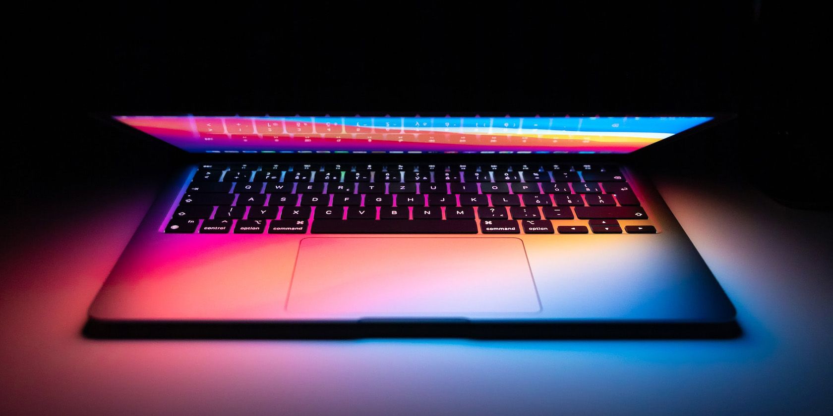 MacBook with lid open in darkness
