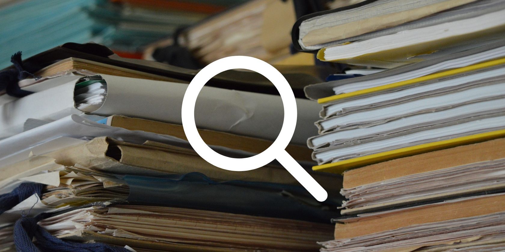 magnifying glass in front of file stack