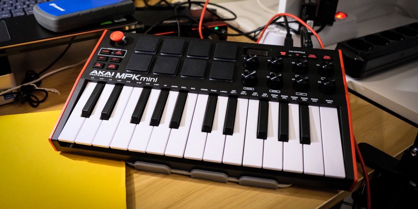 The Akai MPK Mini MIDI keyboard on a desk. 
