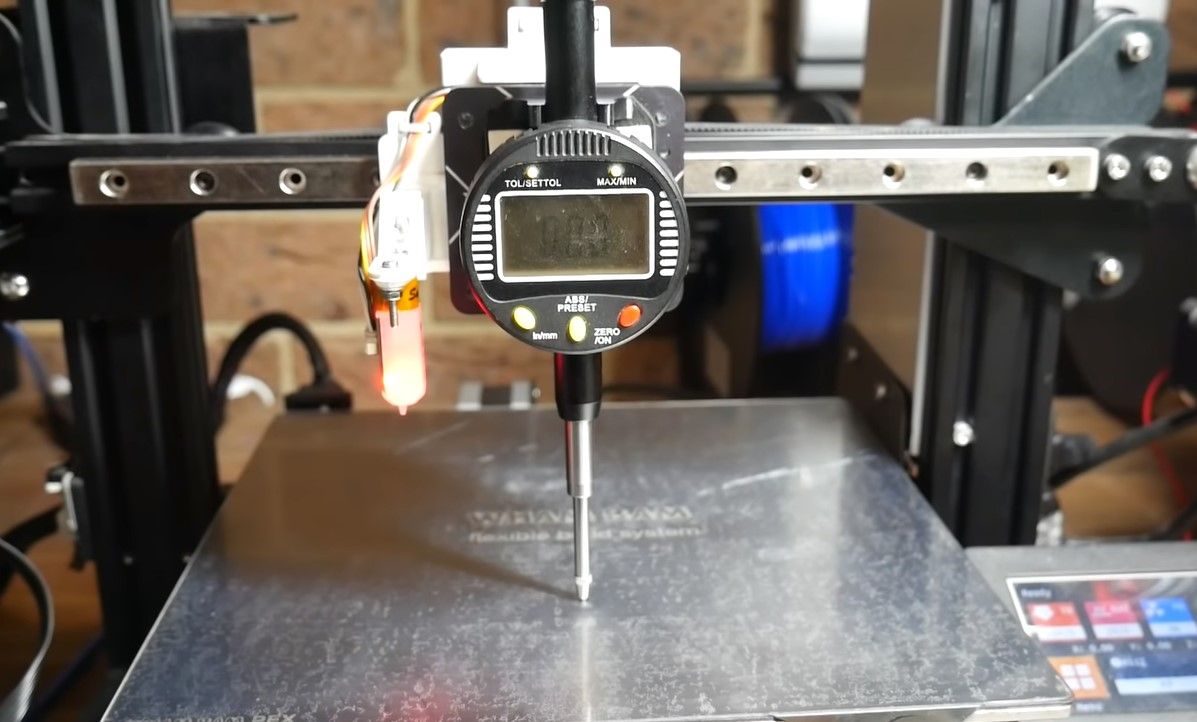 Mounting the dial gauge on the print head of the 3D printer ready to take measurements