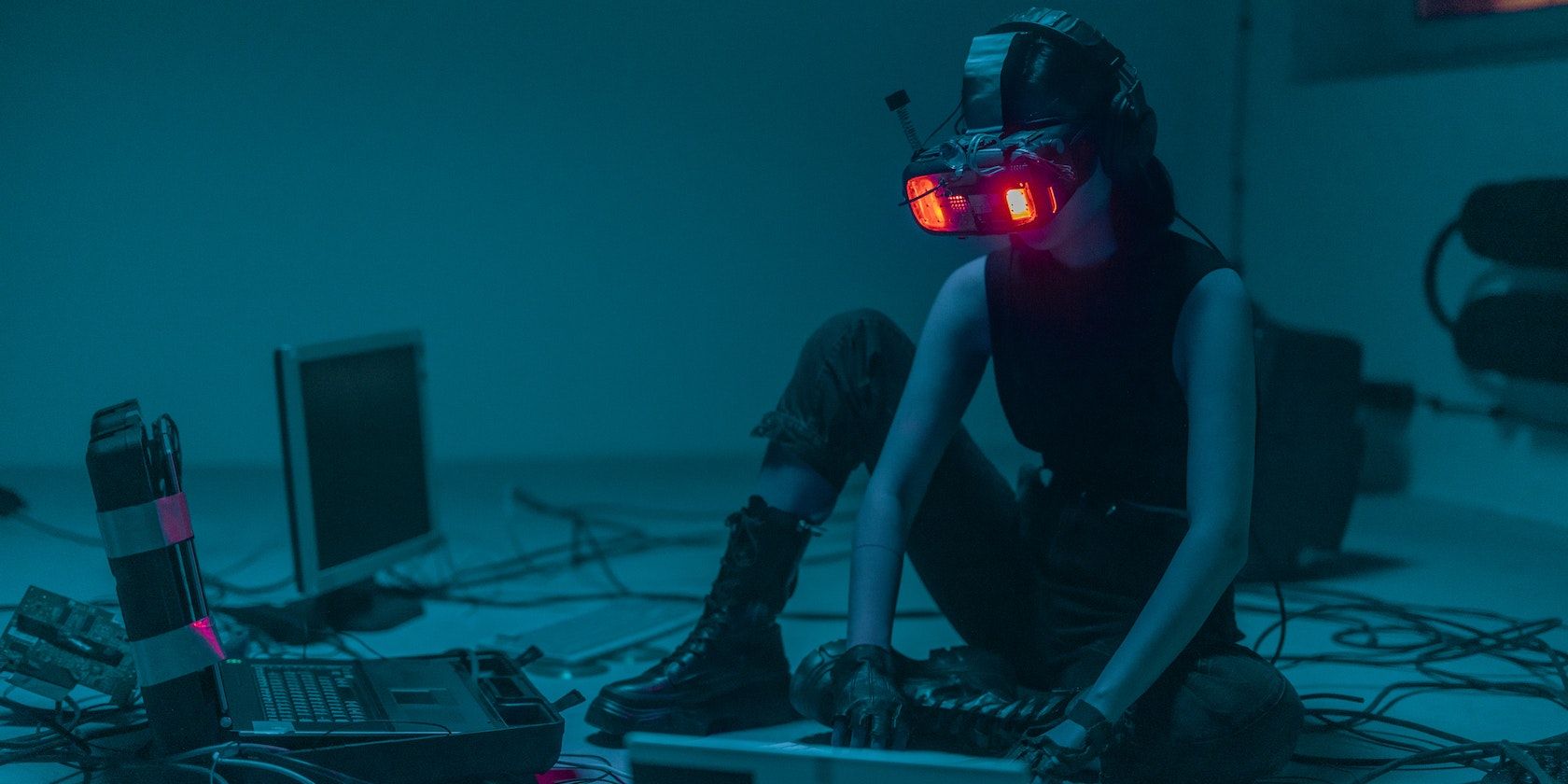 A Person Sitting on the Floor with Vr Goggles Using a Computer