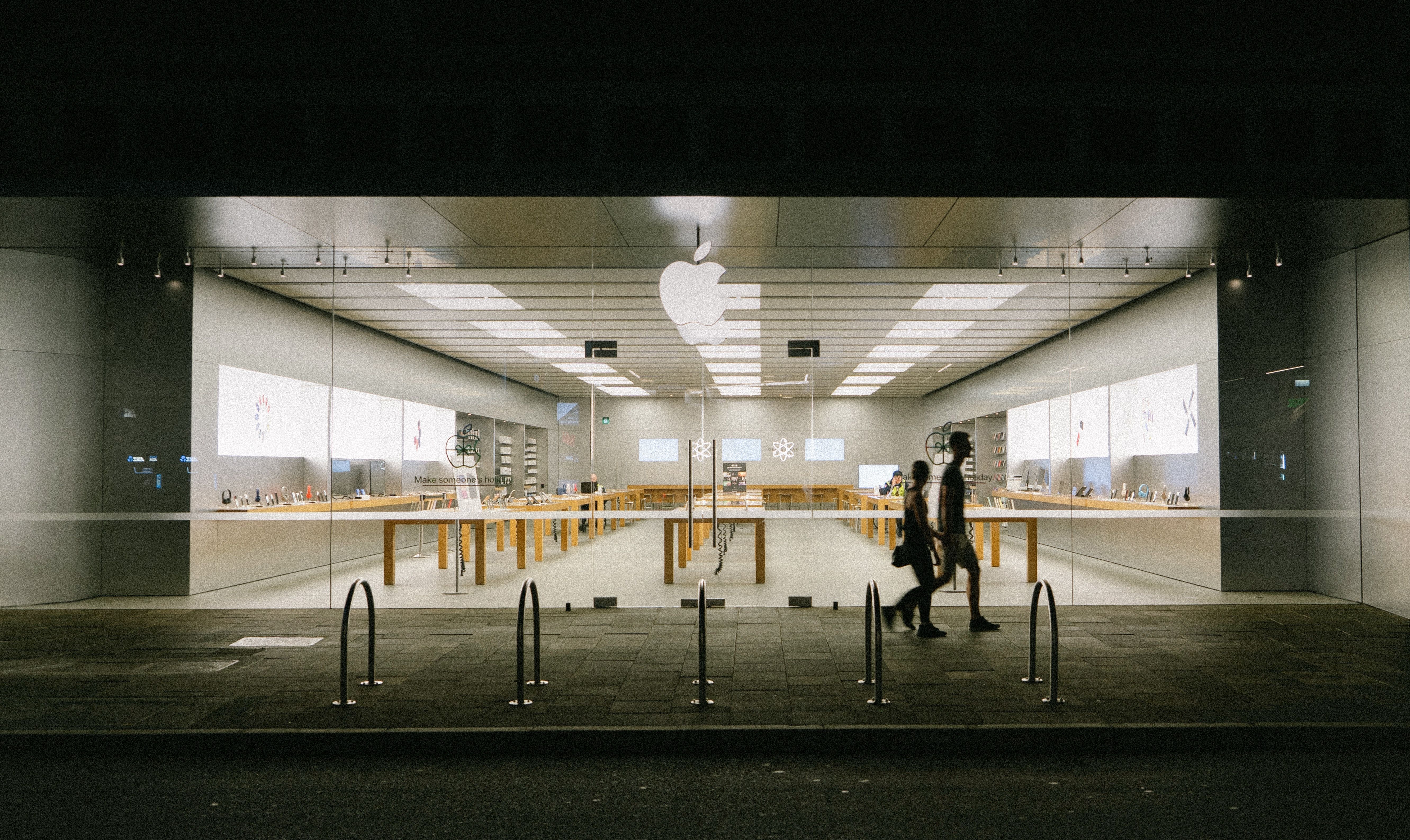 People walking by an Apple Store