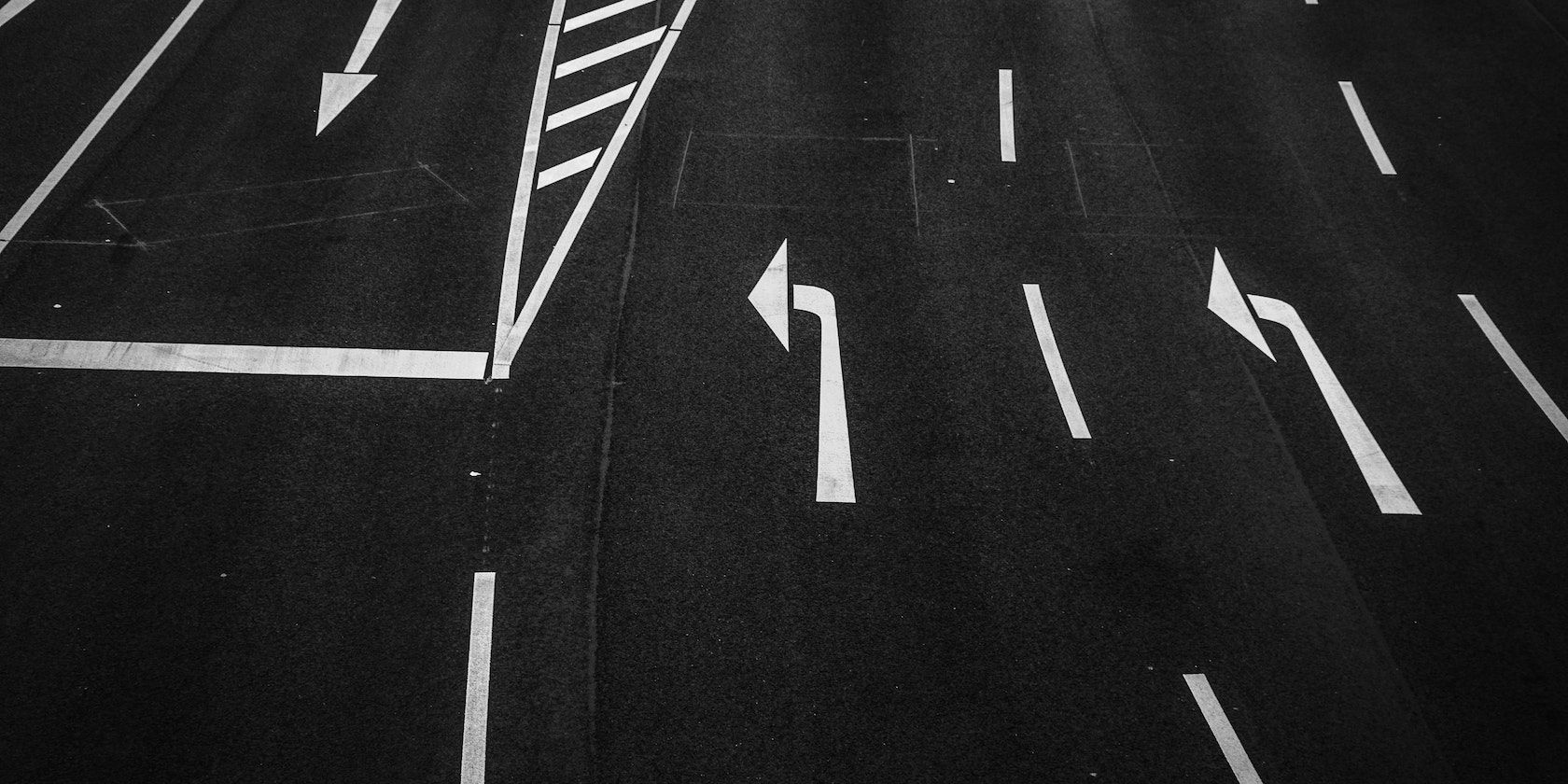 Grayscale photography of road from above
