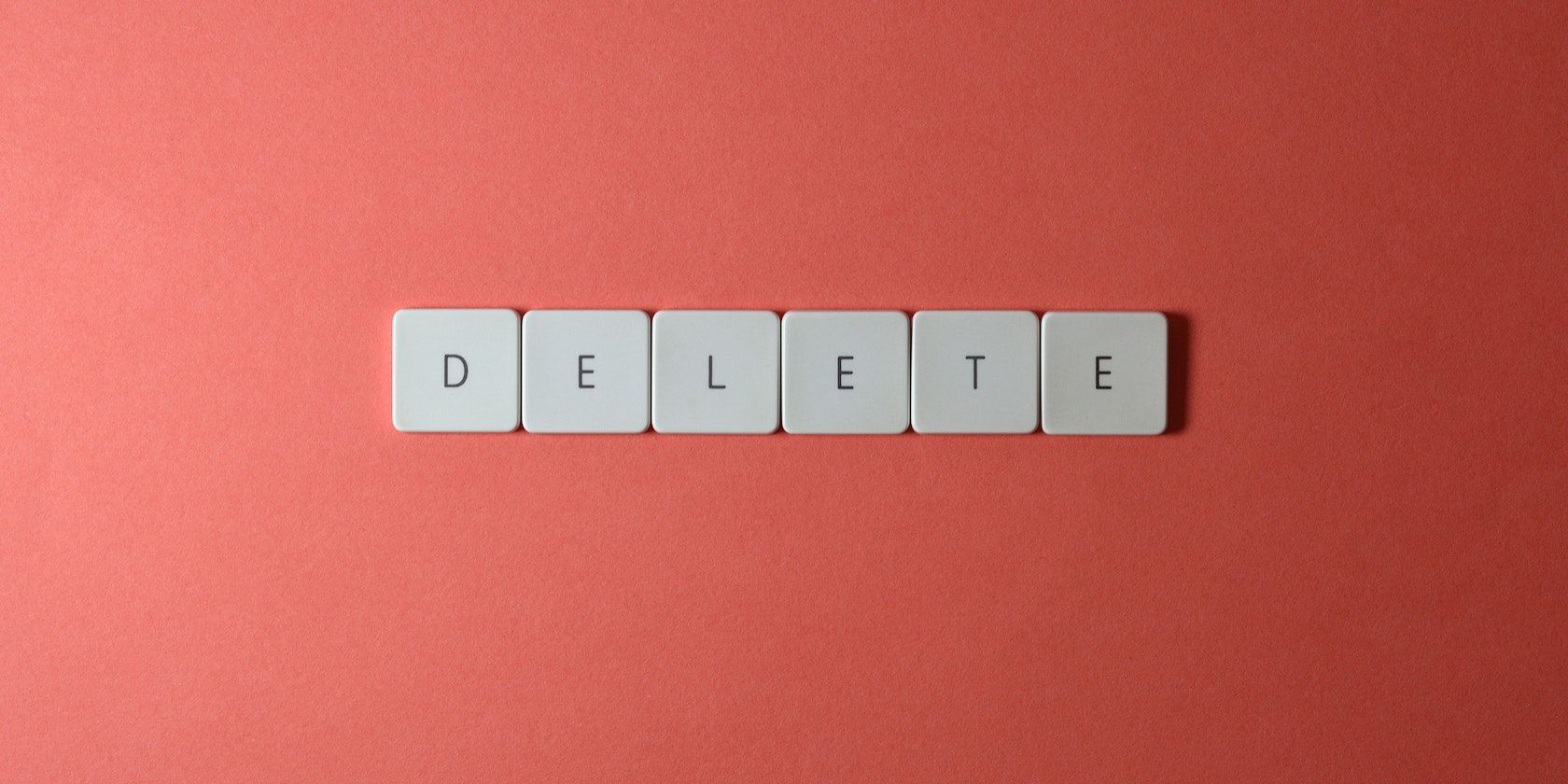 The Delete Word Made With Keyboard Keys on Red Background