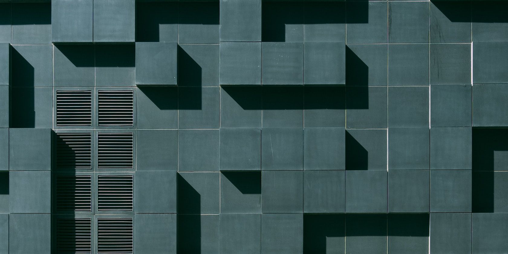 Green Concrete Building Exterior With Geometric Design