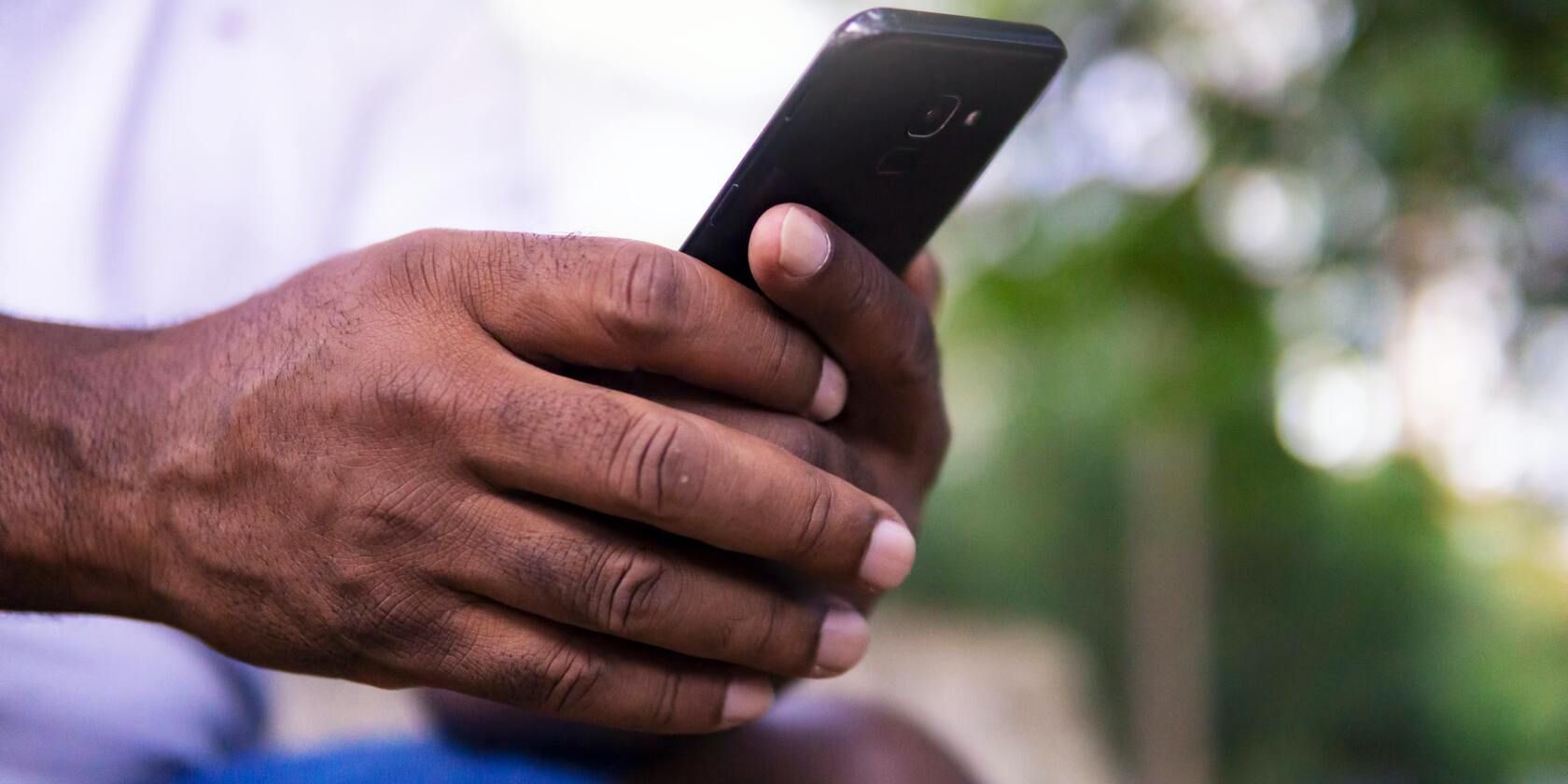 Man holding a black Samsung phone