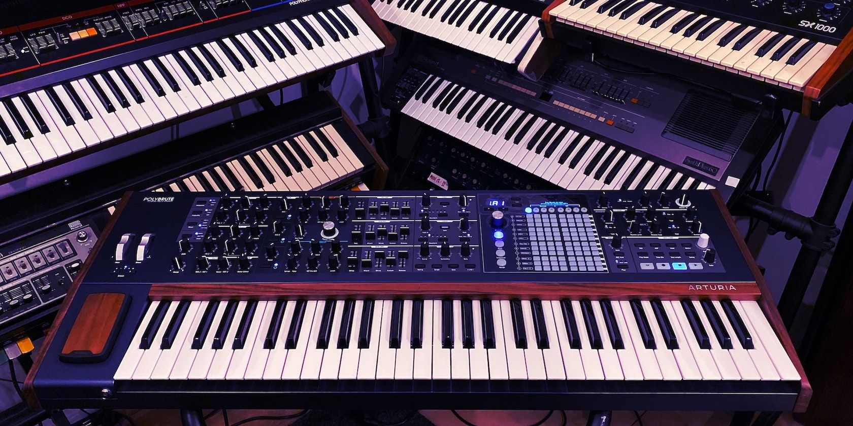 A photo of several synthesizers on racks. 