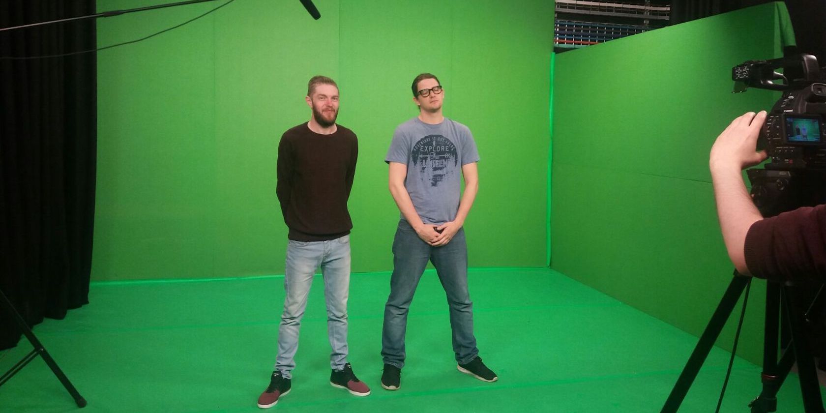 two men standing in front of green screen