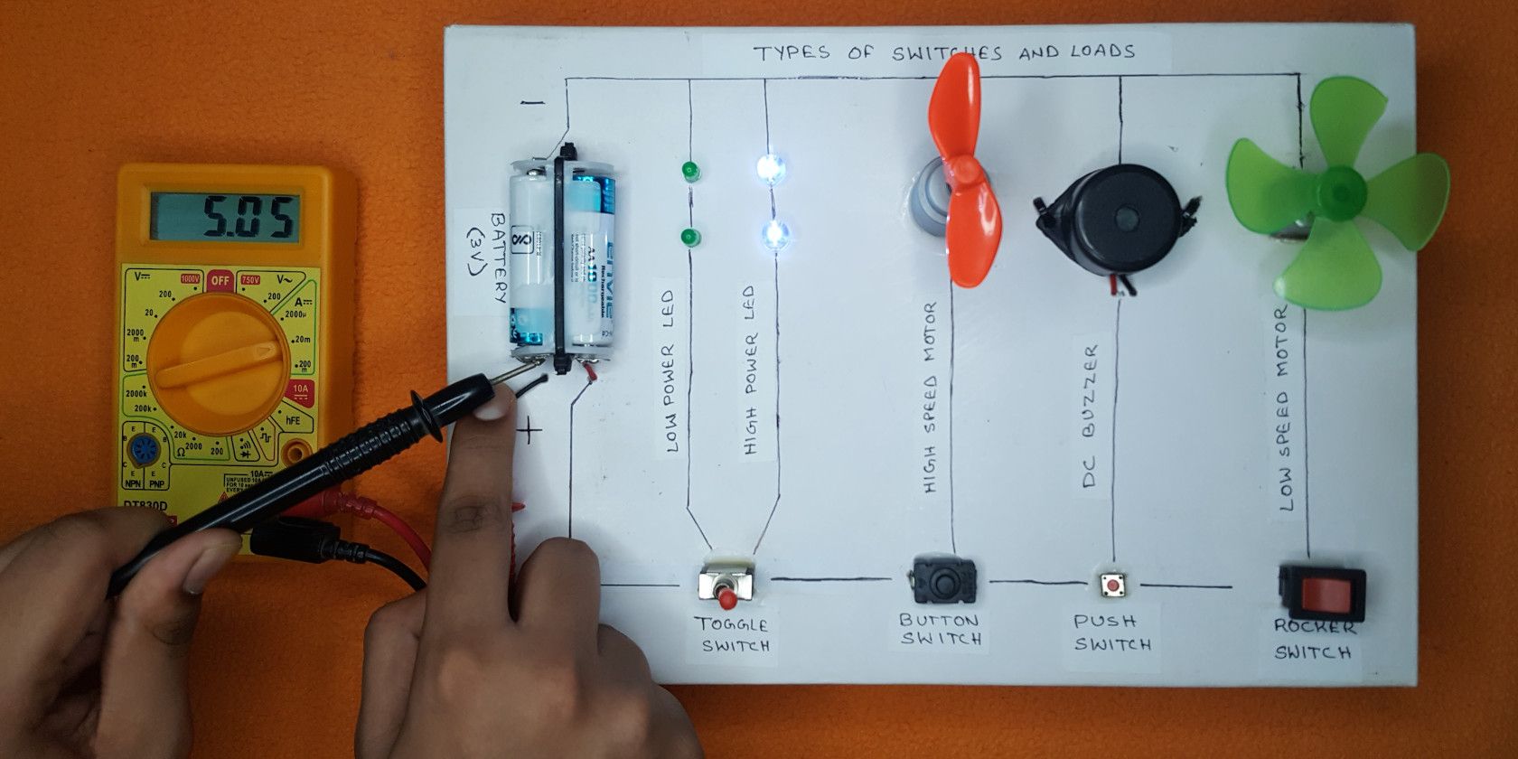 Measuring current with a multimeter of various electronic components fixed to a board