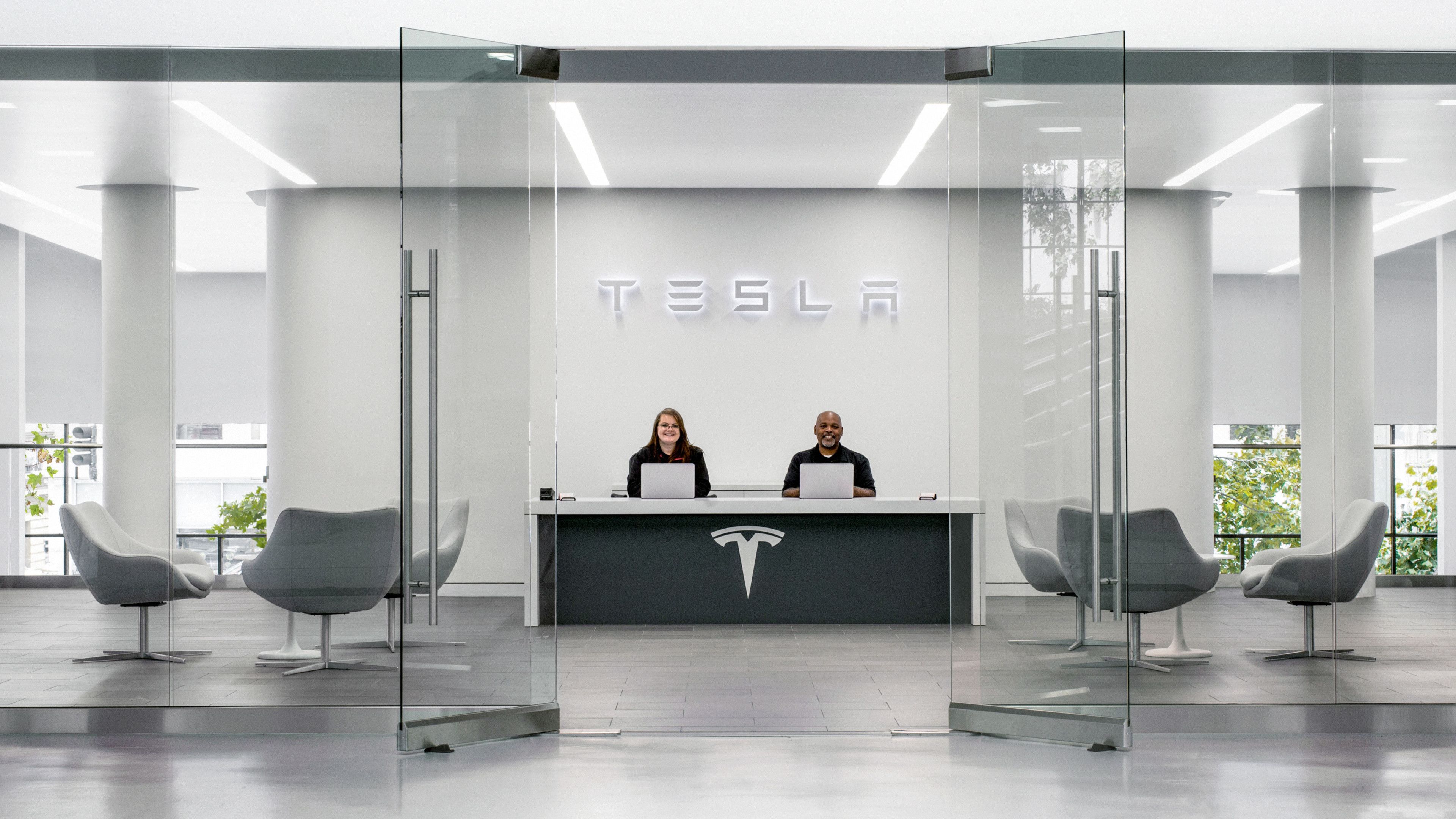 A minimalist Tesla Service Department with two service advisors