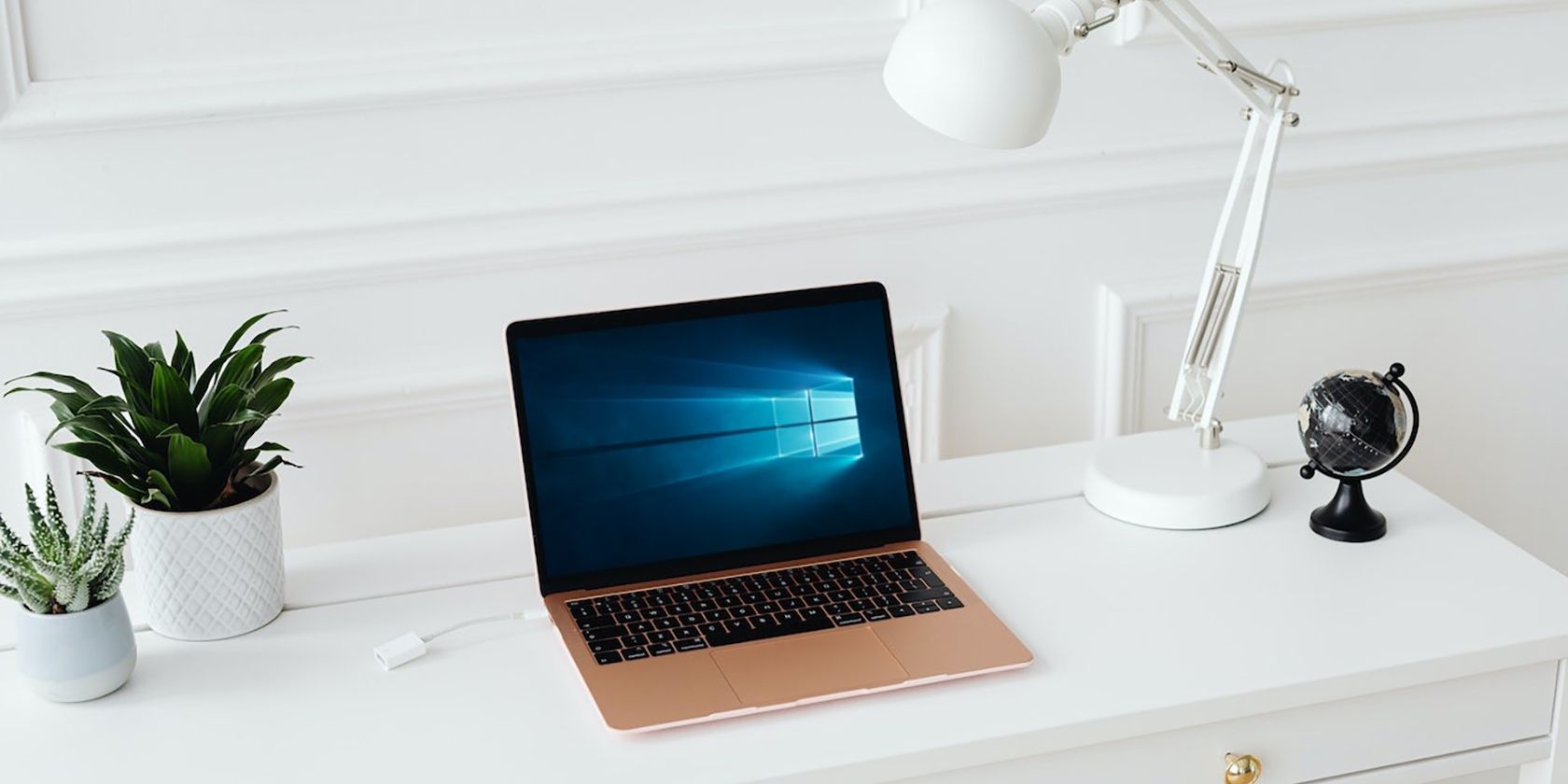 A MacBook Air Placed on a White Desk