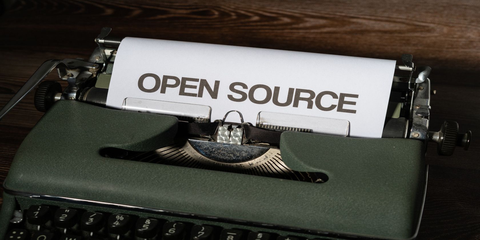 An image of the text 'open source' printed out on a typewriter