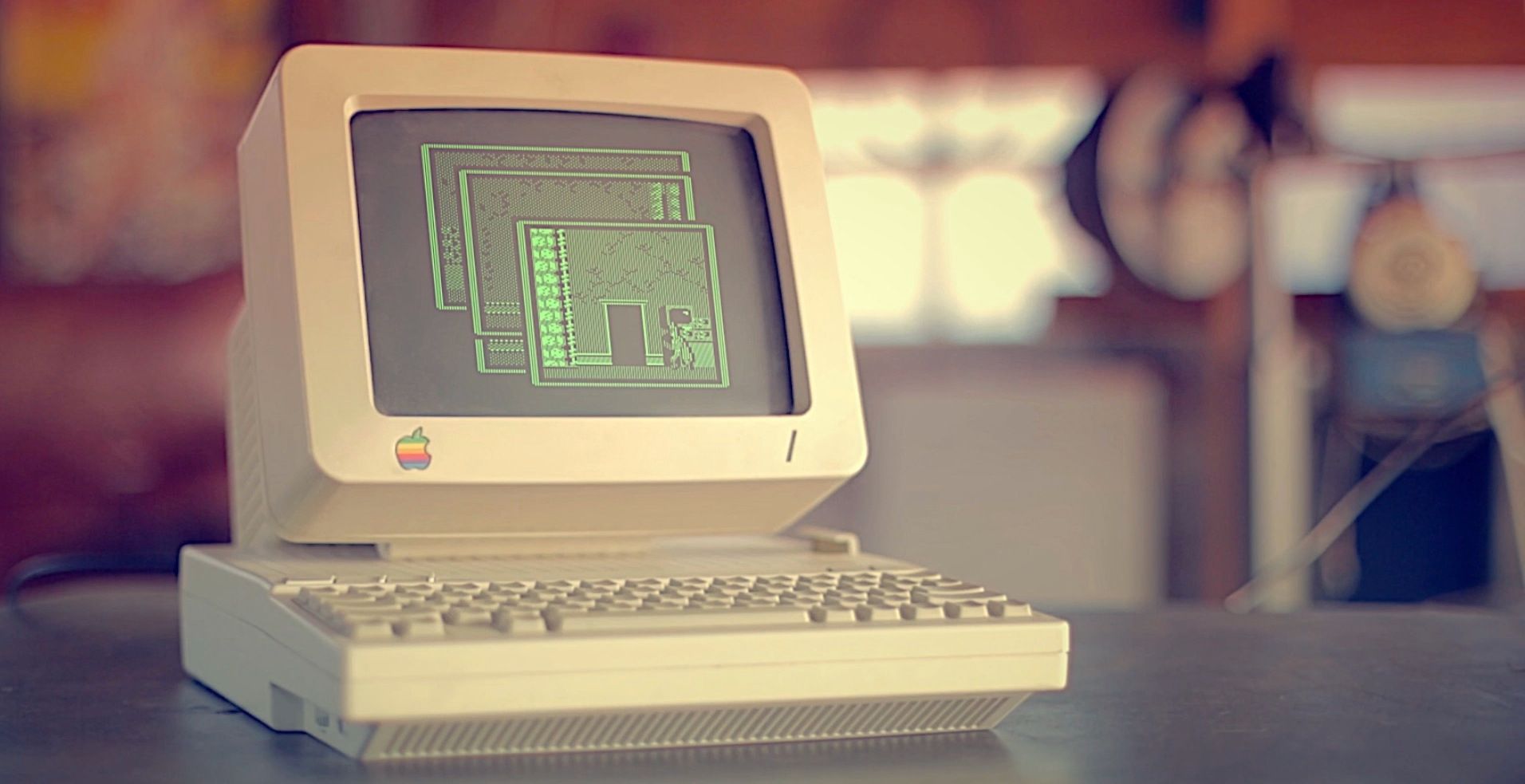 Apple II computer with a game on its screen