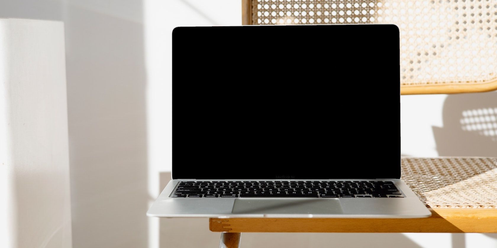 A Blank MacBook Screen Off on a Chair