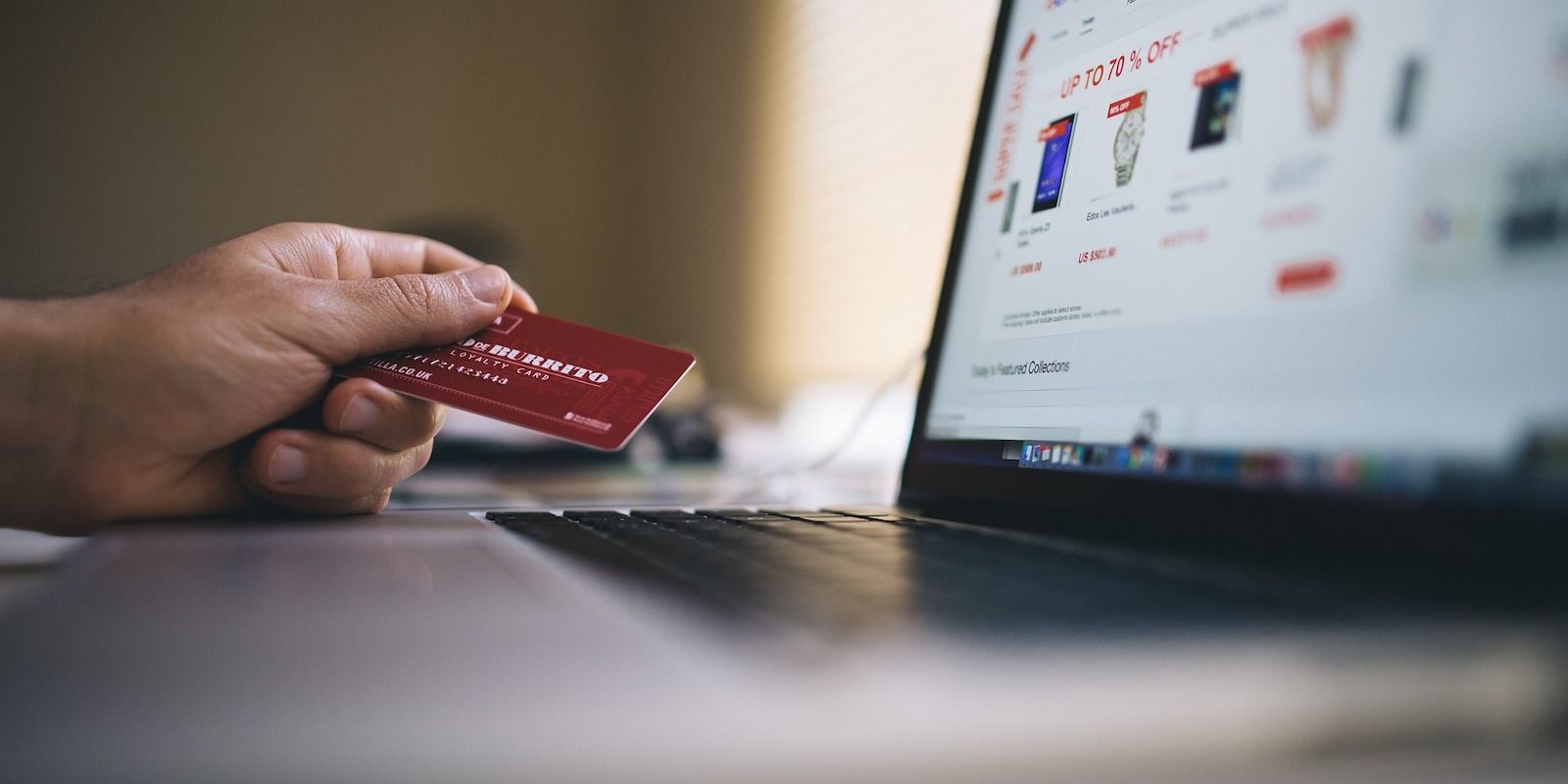 A person holding a credit card when making a card payment online