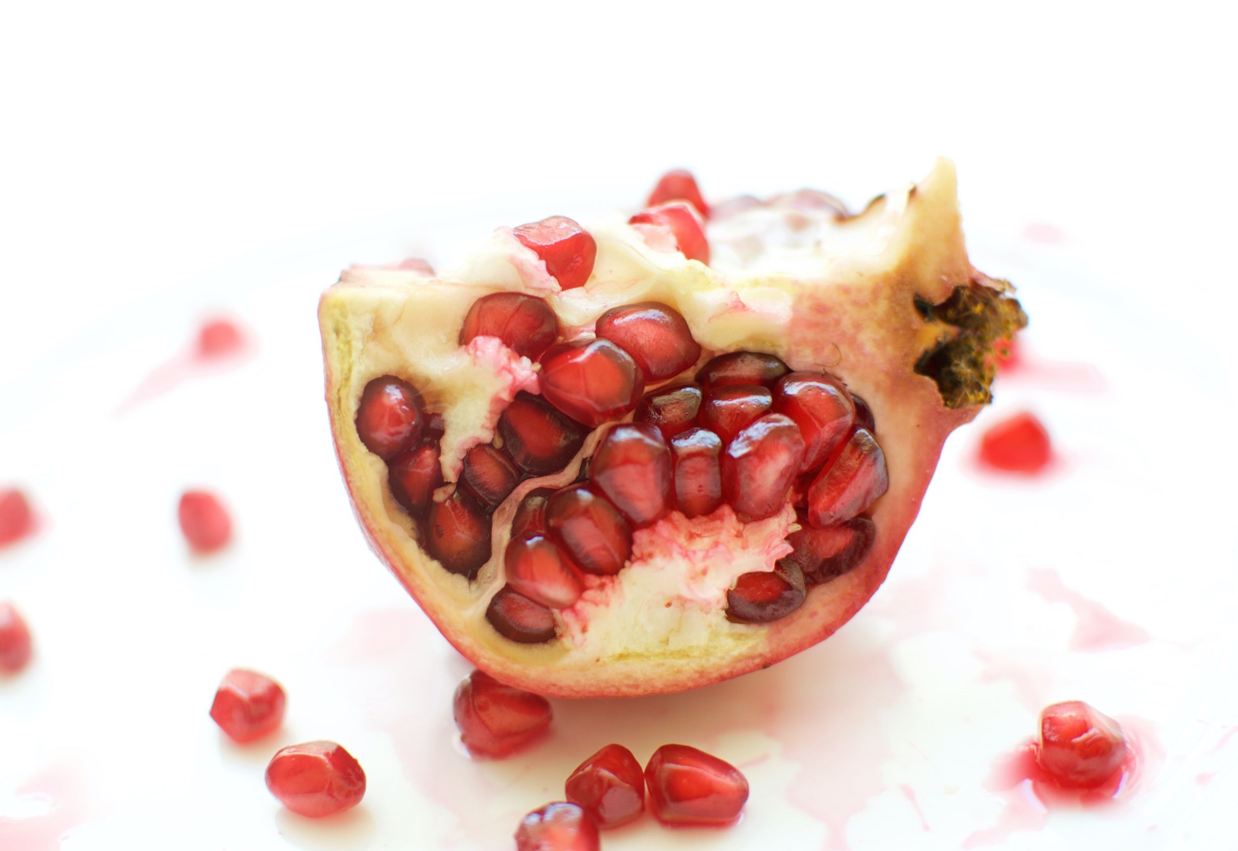 Pomegranate with seeds in the background