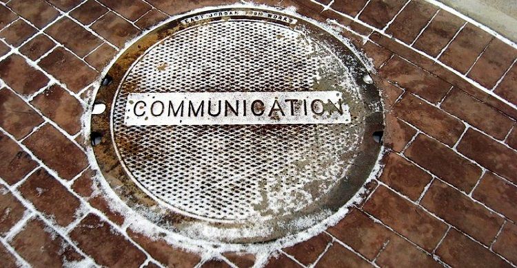 Image of a sewer cover with the word communication on it