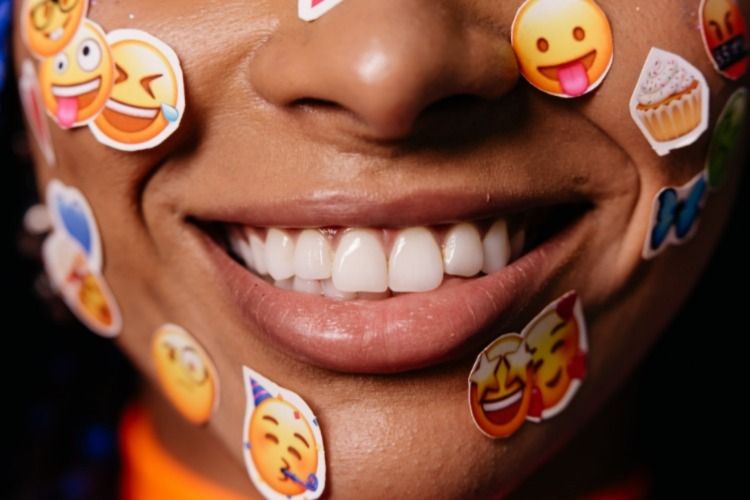 Person with emoji stickers on their face