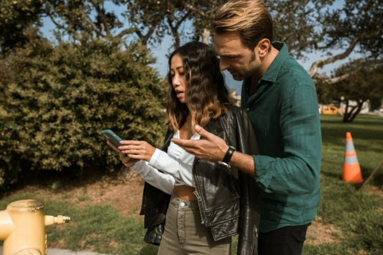 A surprised couple looking at a phone