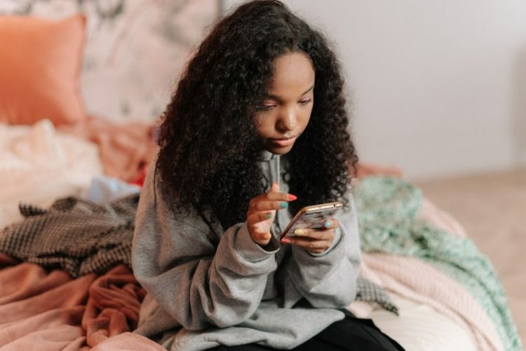 Young woman texting on the phone
