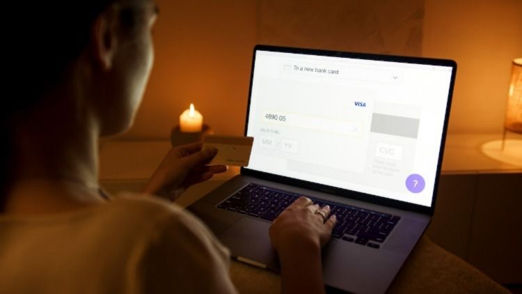 Woman entering a credit card number onto her computer