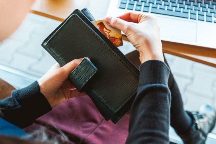 Woman taking credit card from wallet