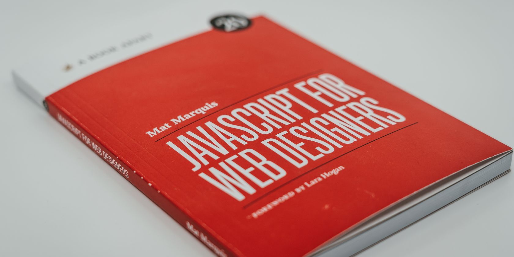 A book with a red cover titled “Javascript for Web Designers”