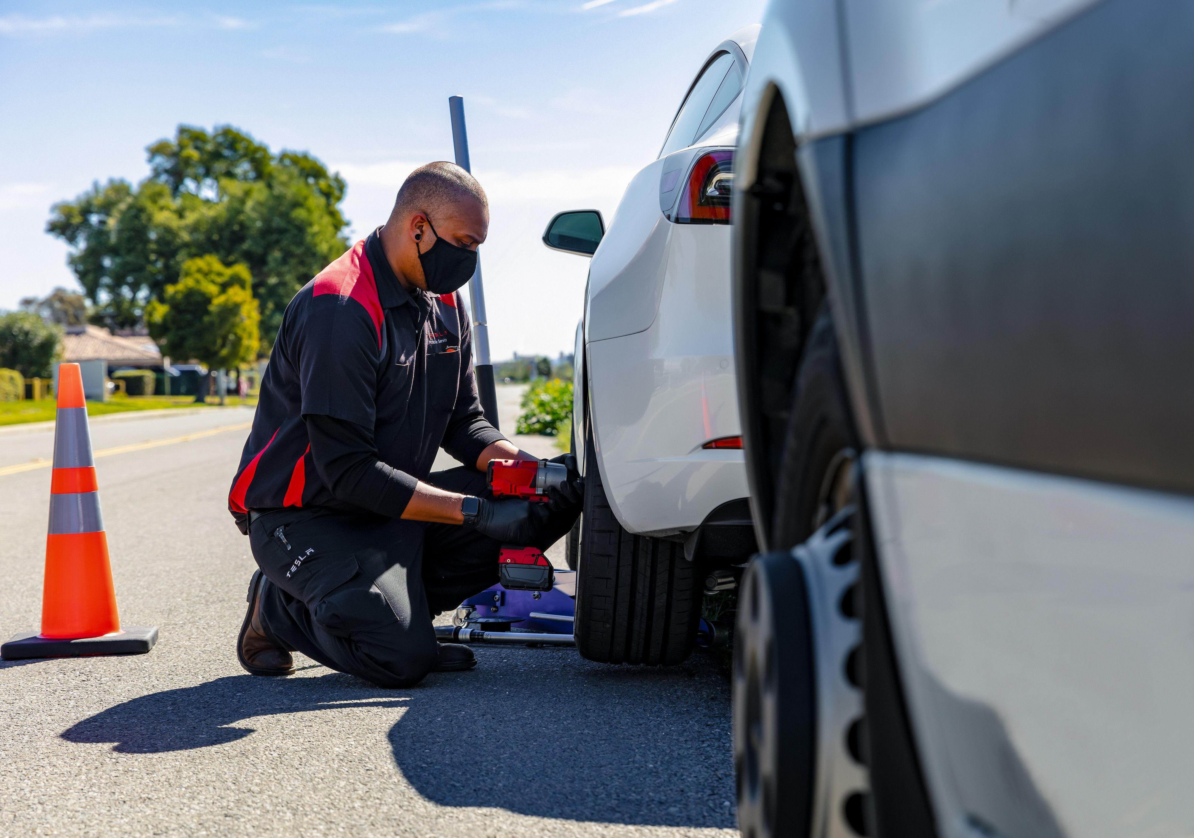 Tesla Technician Checking Tire