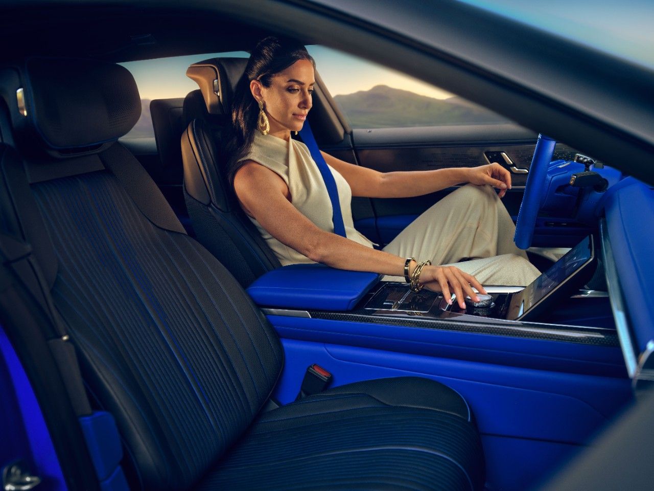 A woman sits in the driver's seat of the Cadillac Celestiq