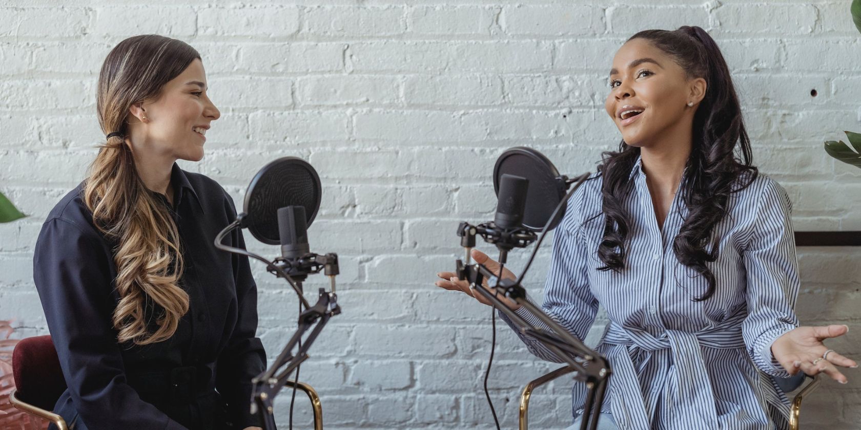 photo of two women making a podcast together