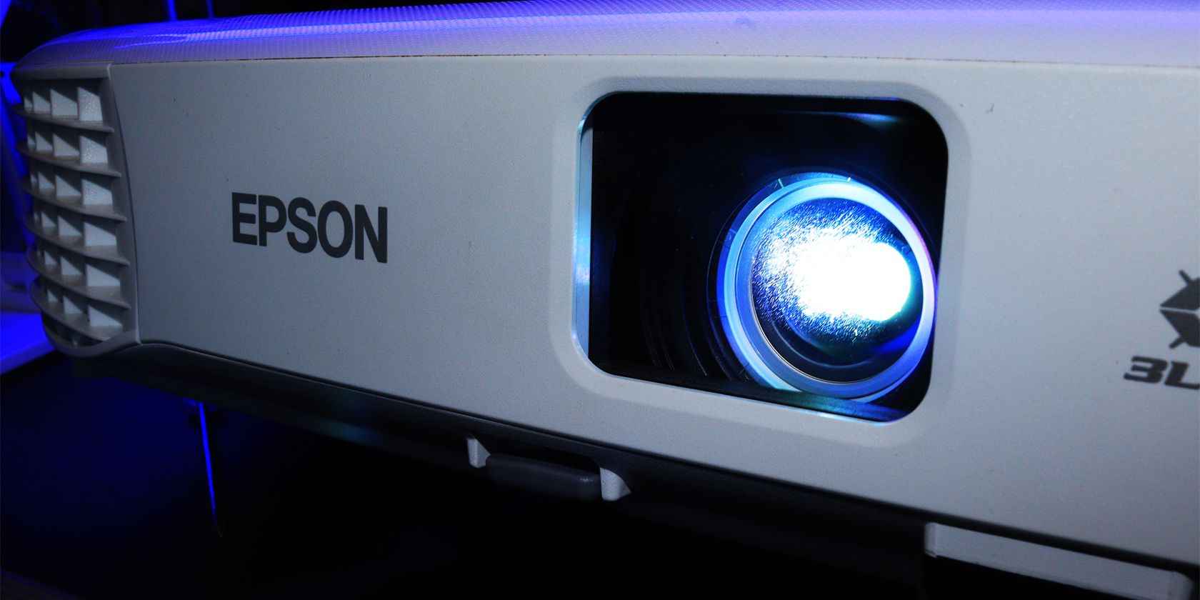 An Epson projector turned on and light emiting from the lens