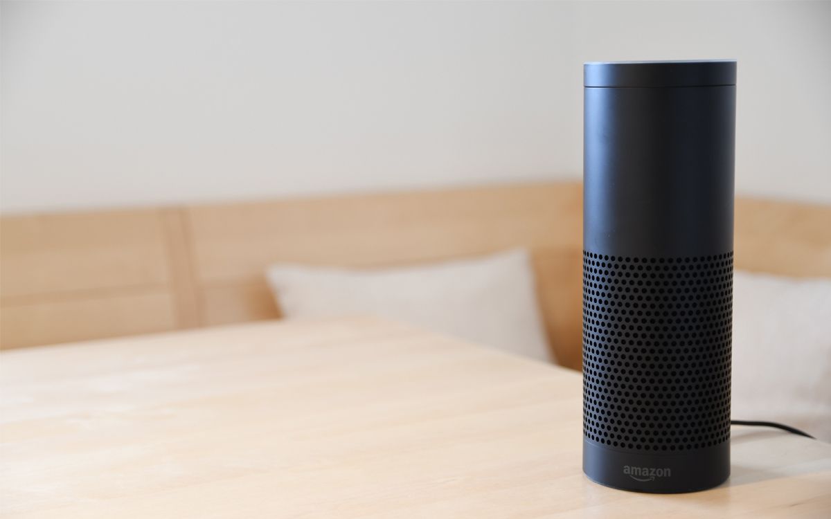 A black Amazon Echo speaker on a table