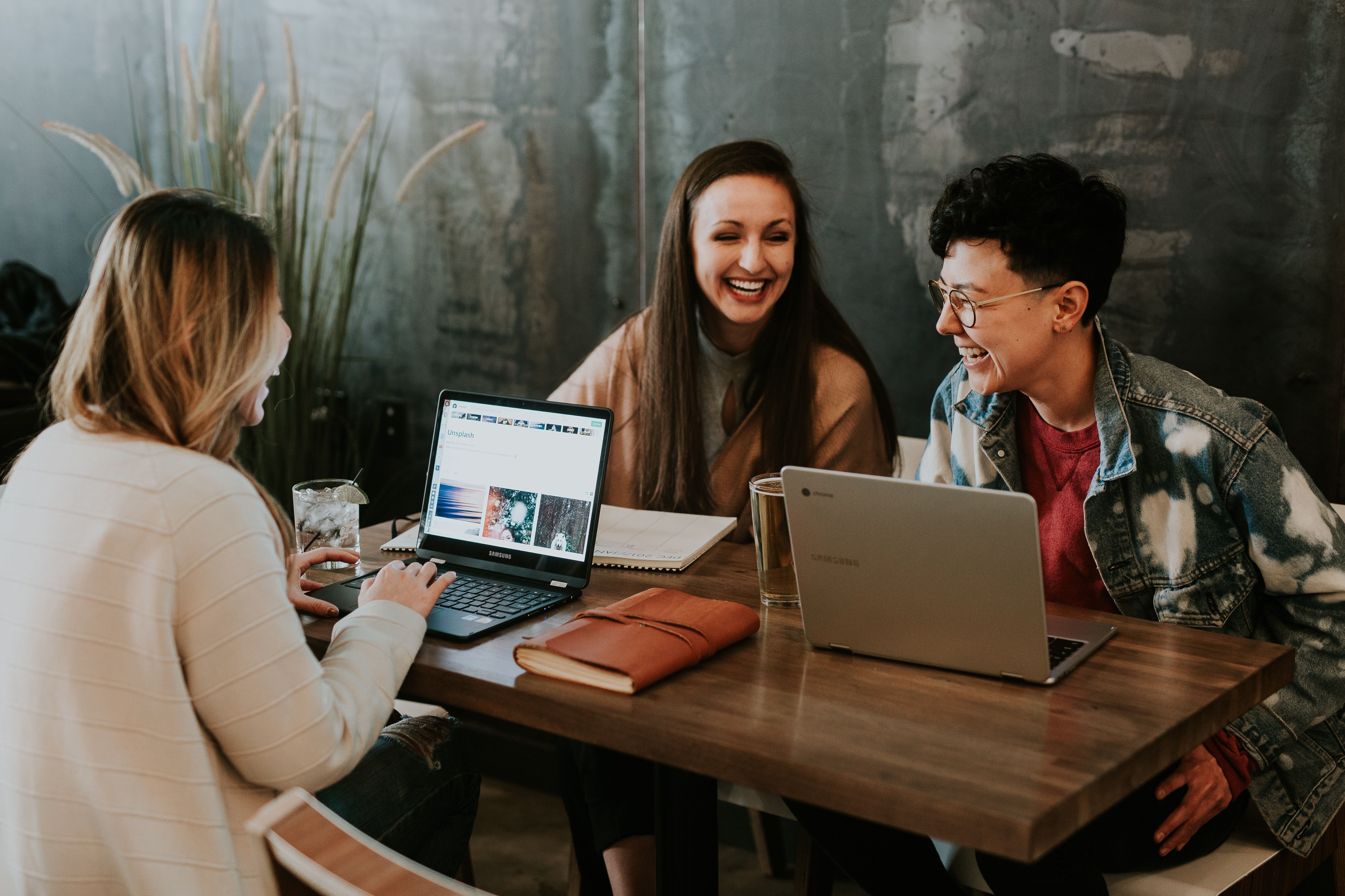 photo of people sitting with their computers at their desk